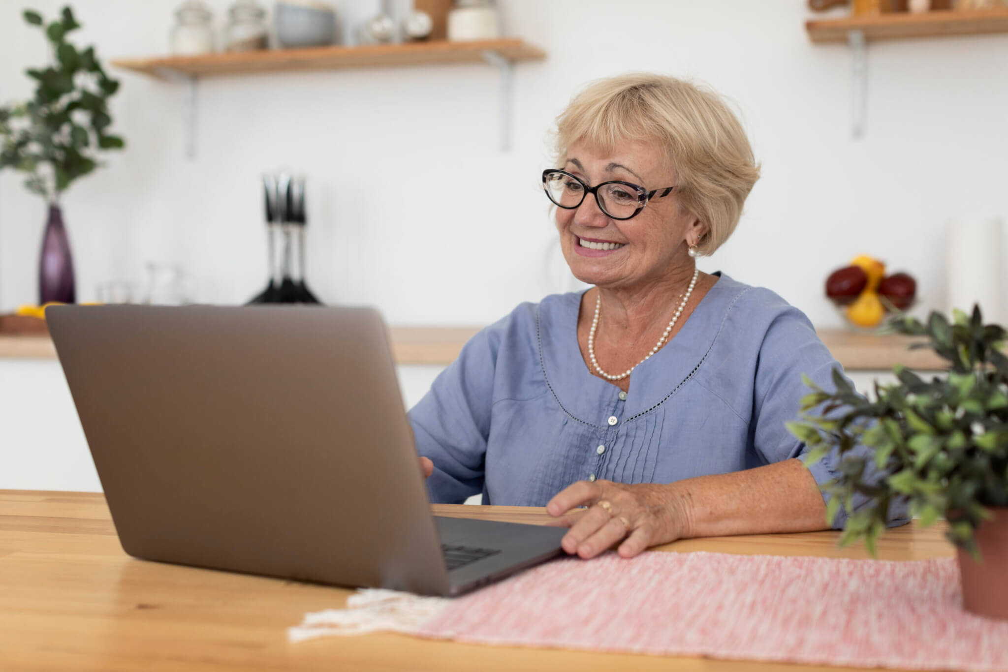 Femme senior seule devant son ordinateur portable
